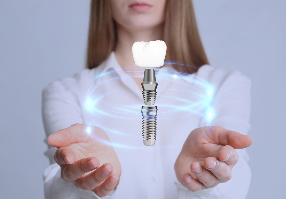 Woman,Demonstrating,Dental,Implant,On,Light,Background,,Closeup
