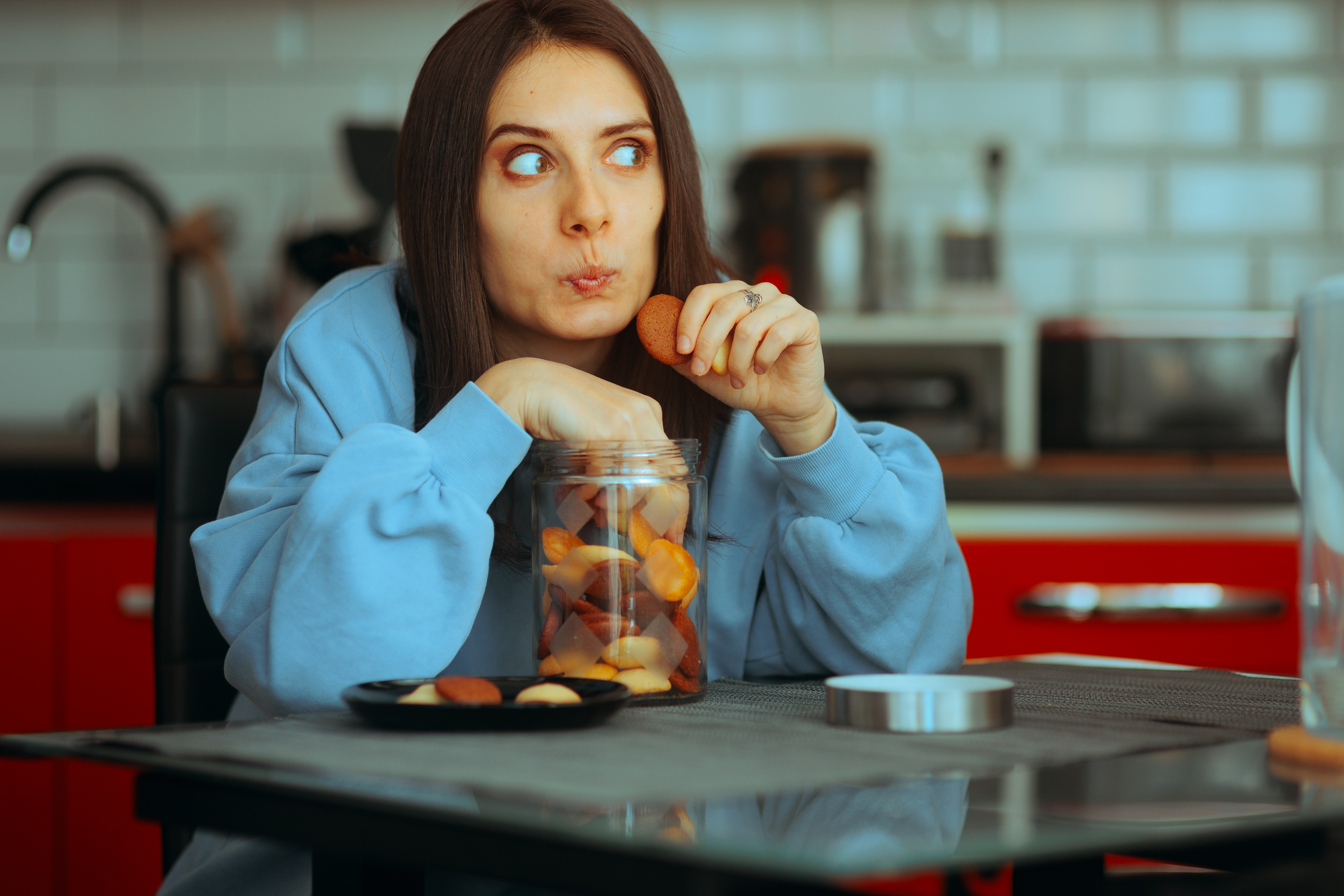 woman stealing cookies ruining her diet